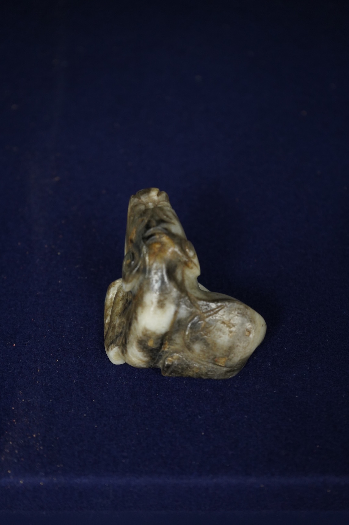 A Chinese white and black jade mythical beast, 5cm wide